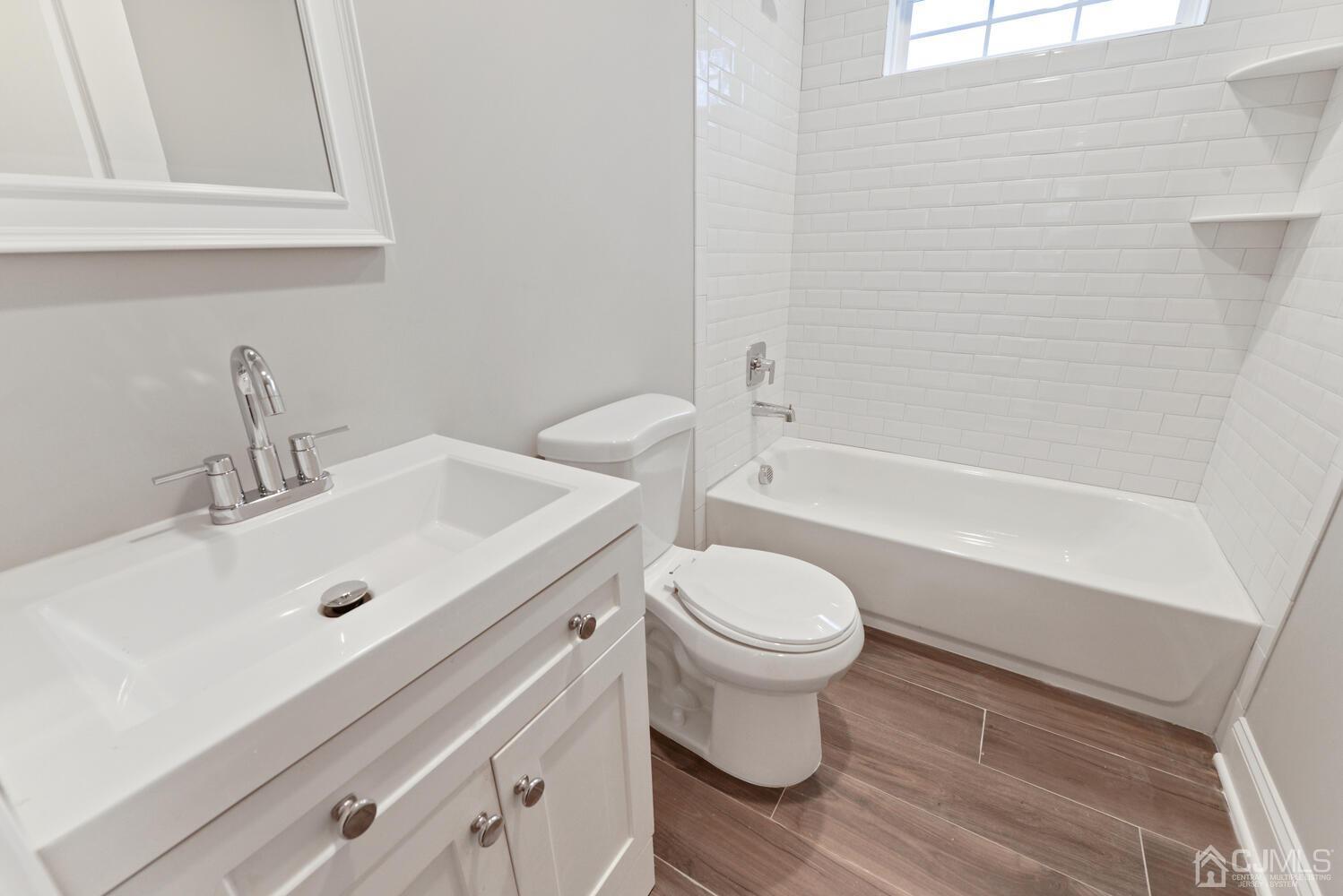 20 Sunset Drive Clark, NJ 07066 - Photo 24 of 32 a bathroom with a sink and a mirror