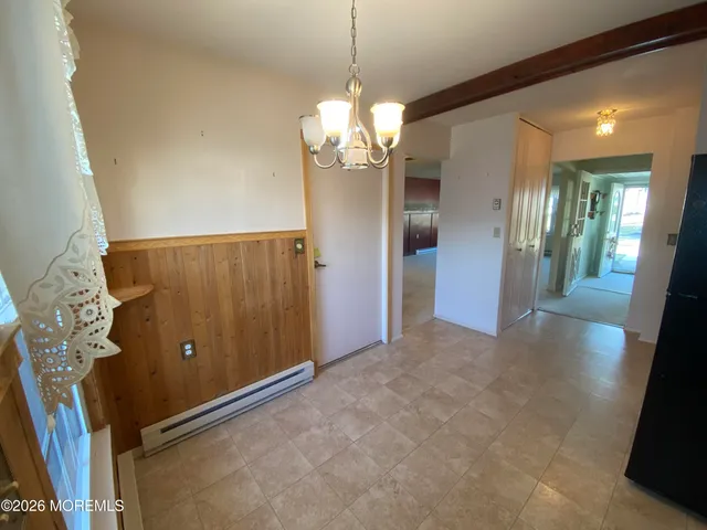 a kitchen with kitchen island white cabinets and refrigerator
