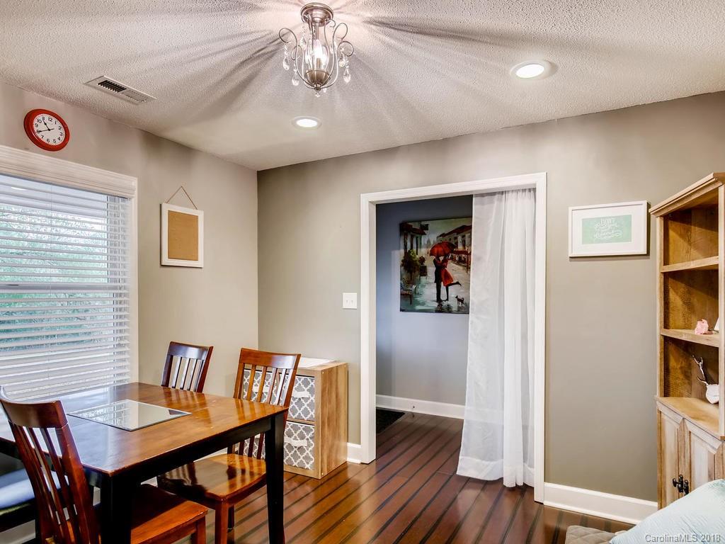 2411 Medlin Road Monroe, NC 28112 - Photo 15 of 27 a view of a dining room with furniture window and wooden floor