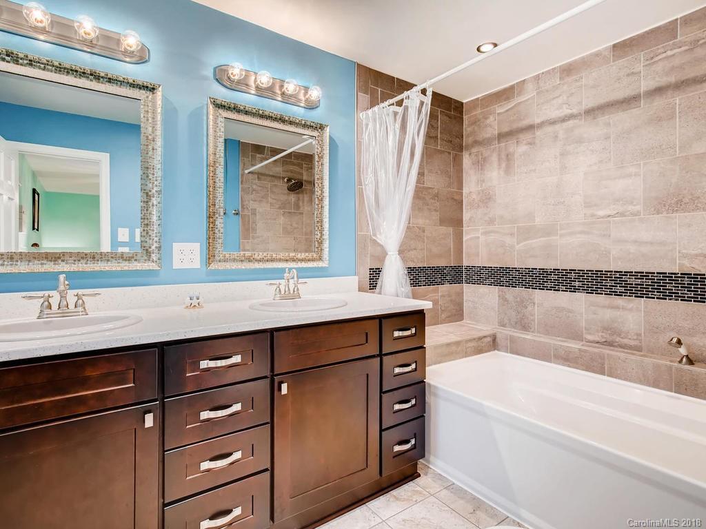 2411 Medlin Road Monroe, NC 28112 - Photo 18 of 27 a bathroom with a bathtub and a sink