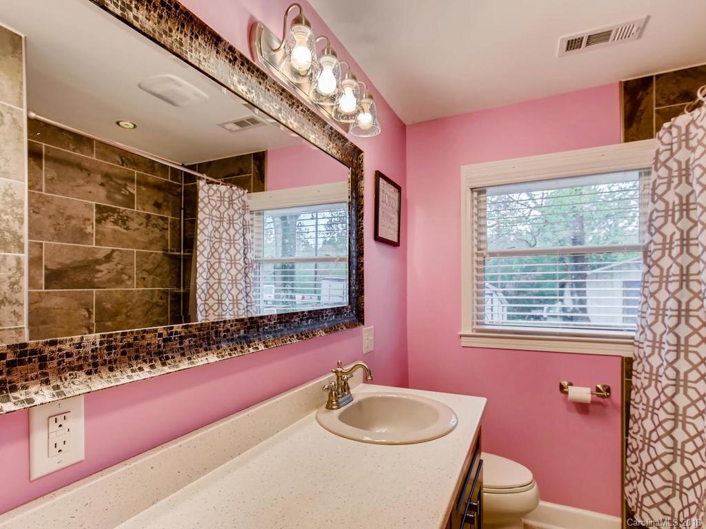 2411 Medlin Road Monroe, NC 28112 - Photo 21 of 27 a bathroom with a sink vanity mirror and toilet