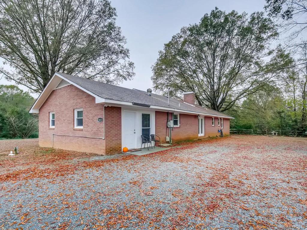 2411 Medlin Road Monroe, NC 28112 - Photo 26 of 27 a house with trees in the background