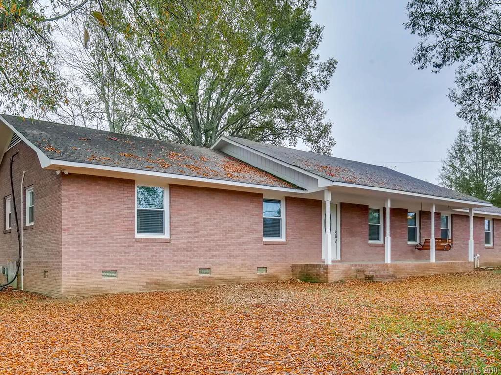 2411 Medlin Road Monroe, NC 28112 - Photo 4 of 27 a front view of a house with a garden