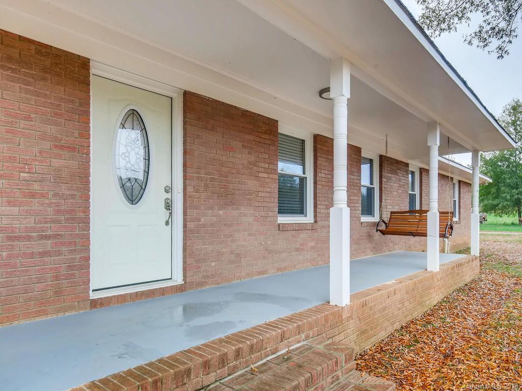 2411 Medlin Road Monroe, NC 28112 - Photo 5 of 27 a front view of a house with a garden
