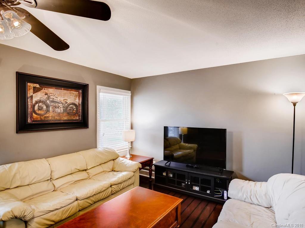 2411 Medlin Road Monroe, NC 28112 - Photo 6 of 27 a living room with furniture and a flat screen tv