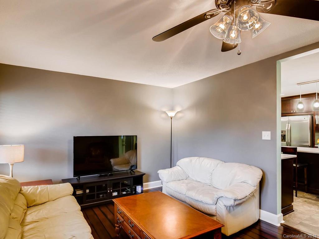 2411 Medlin Road Monroe, NC 28112 - Photo 7 of 27 a living room with furniture and a flat screen tv