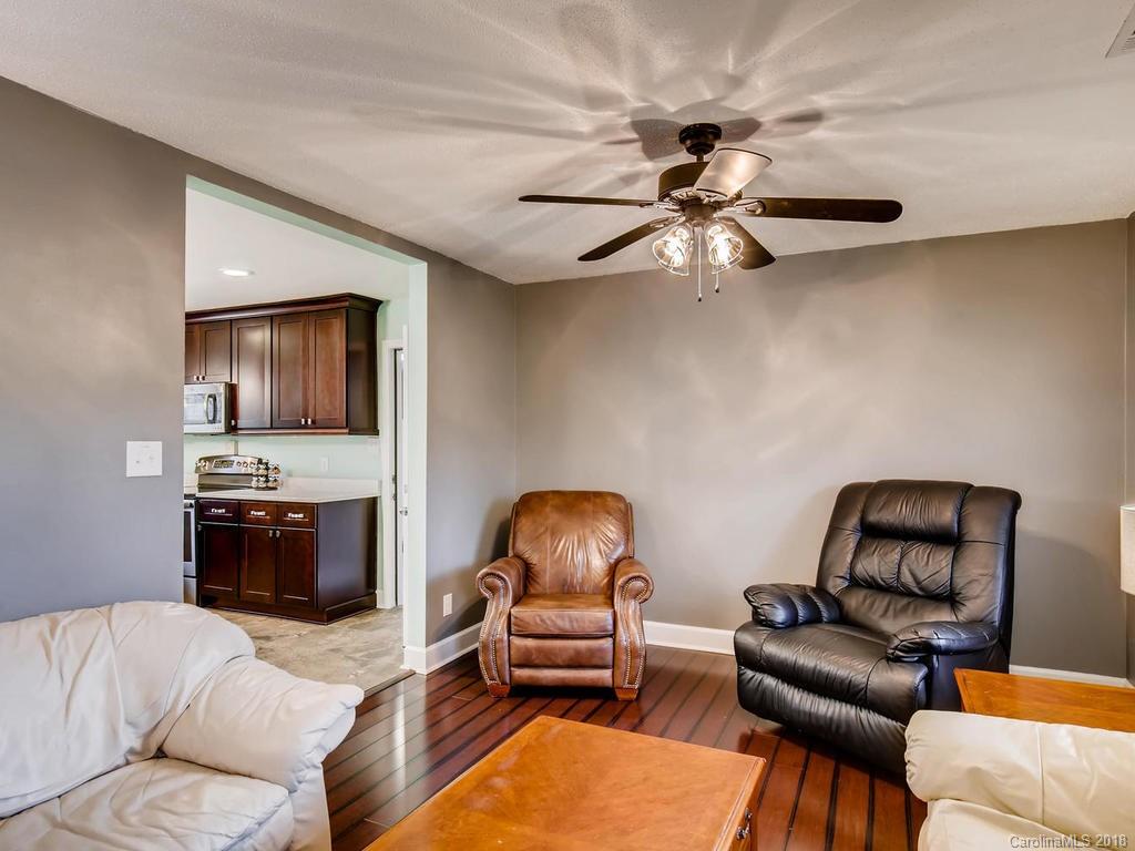 2411 Medlin Road Monroe, NC 28112 - Photo 8 of 27 a living room with furniture and a flat screen tv