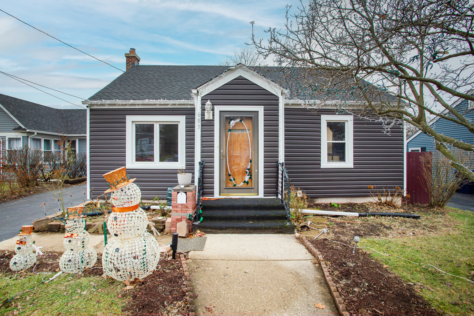 683 Columbia Avenue Elgin, IL 60120 - Photo 2 of 29 a front view of a house with garden