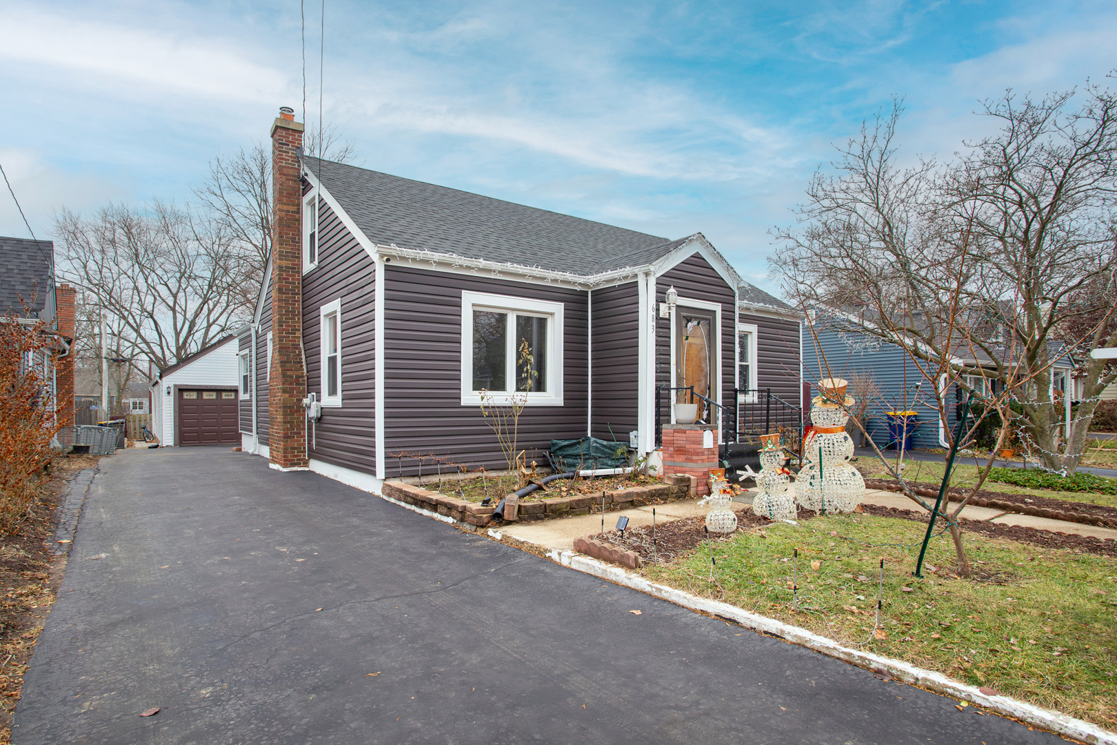 683 Columbia Avenue Elgin, IL 60120 - Photo 3 of 29 a front view of a house with garden and trees