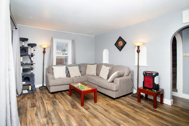 a living room with furniture and a wooden floor
