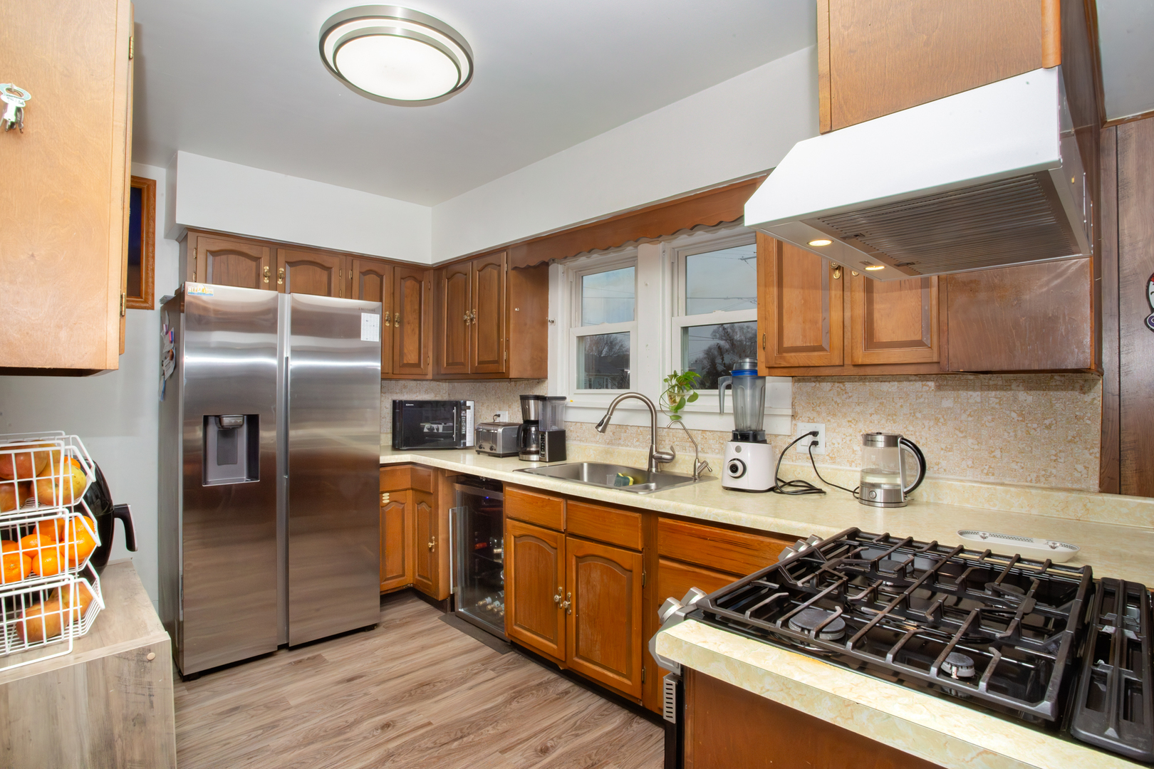 683 Columbia Avenue Elgin, IL 60120 - Photo 6 of 29 a kitchen with stainless steel appliances granite countertop a stove a sink dishwasher a refrigerator and wooden cabinets with wooden floor