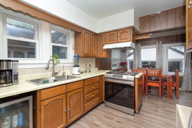 a kitchen with stainless steel appliances granite countertop a sink stove and cabinets