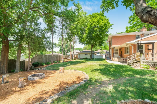 a view of a house with backyard and sitting area