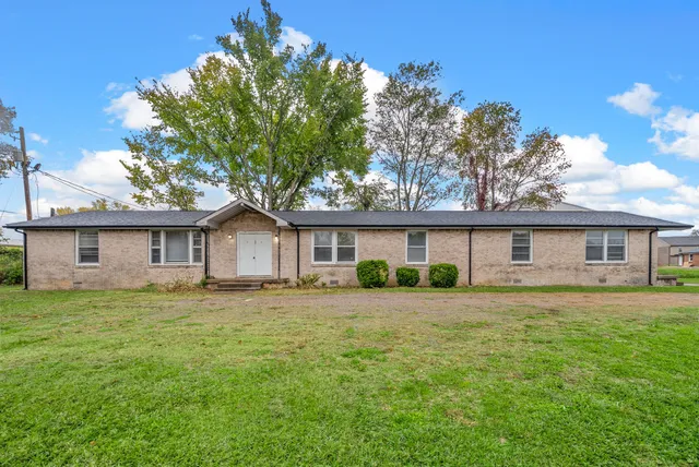 a house that has a tree in front of it