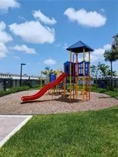 a view of a park with slide and bench