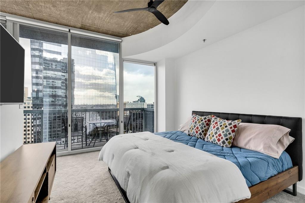 3324 Peachtree Road Northeast, Unit 1813 Atlanta, GA 30326 - Photo 11 of 34 a bedroom with a large bed and a large window