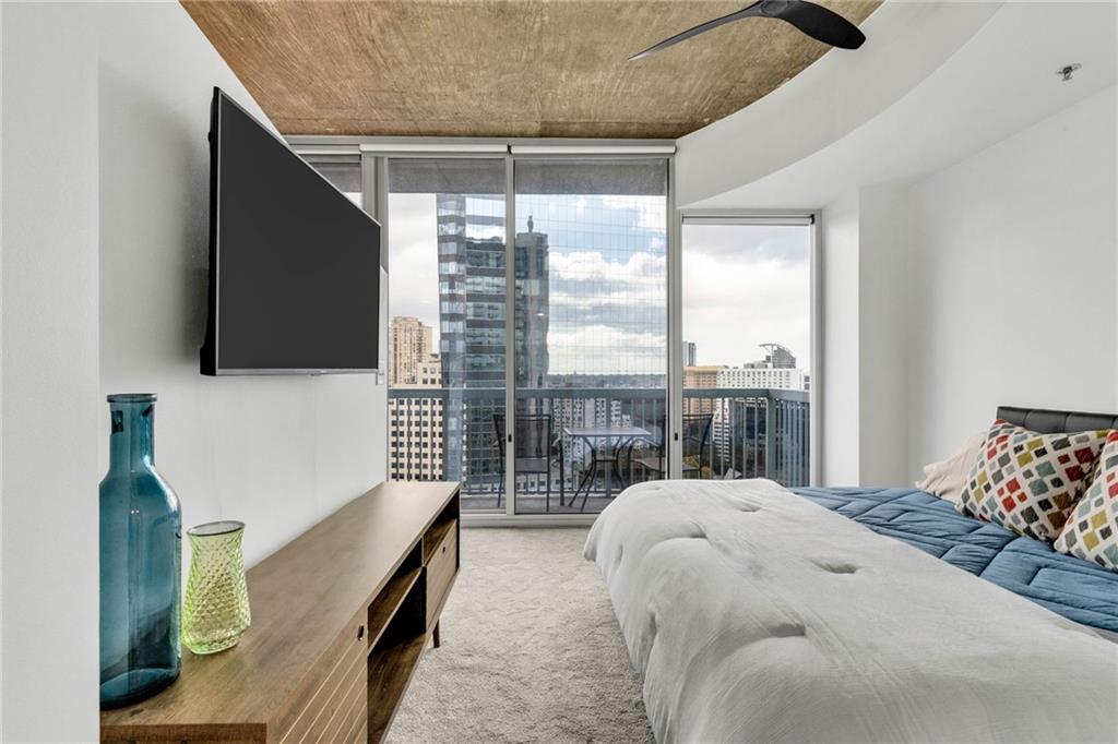 3324 Peachtree Road Northeast, Unit 1813 Atlanta, GA 30326 - Photo 12 of 34 a bed sitting in a bedroom next to a window