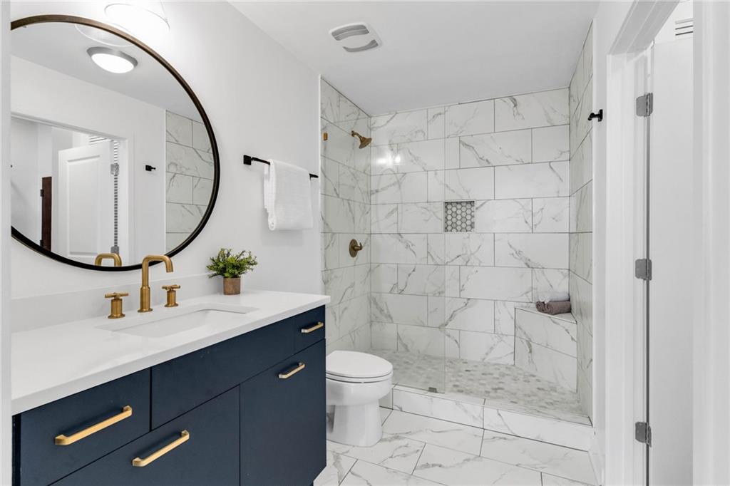 3324 Peachtree Road Northeast, Unit 1813 Atlanta, GA 30326 - Photo 15 of 34 a bathroom with a sink a toilet and shower