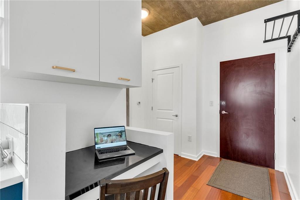 3324 Peachtree Road Northeast, Unit 1813 Atlanta, GA 30326 - Photo 19 of 34 a bedroom with a bed and a desk