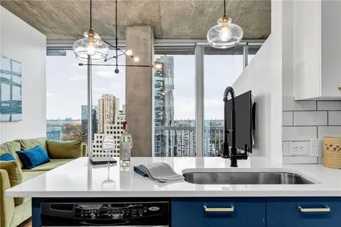 a view of a dining room with furniture wooden floor and chandelier