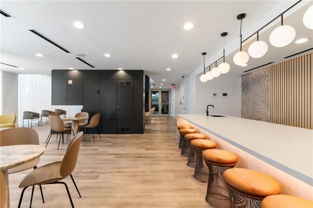 3324 Peachtree Road Northeast, Unit 1813 Atlanta, GA 30326 - Photo 30 of 34 a large room with wooden floor and furniture