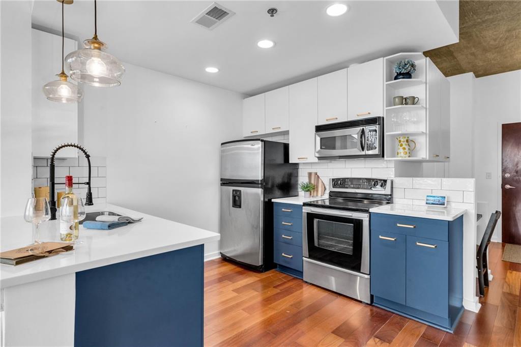 3324 Peachtree Road Northeast, Unit 1813 Atlanta, GA 30326 - Photo 4 of 34 a kitchen with stainless steel appliances granite countertop a sink a stove a refrigerator cabinets and a dining table