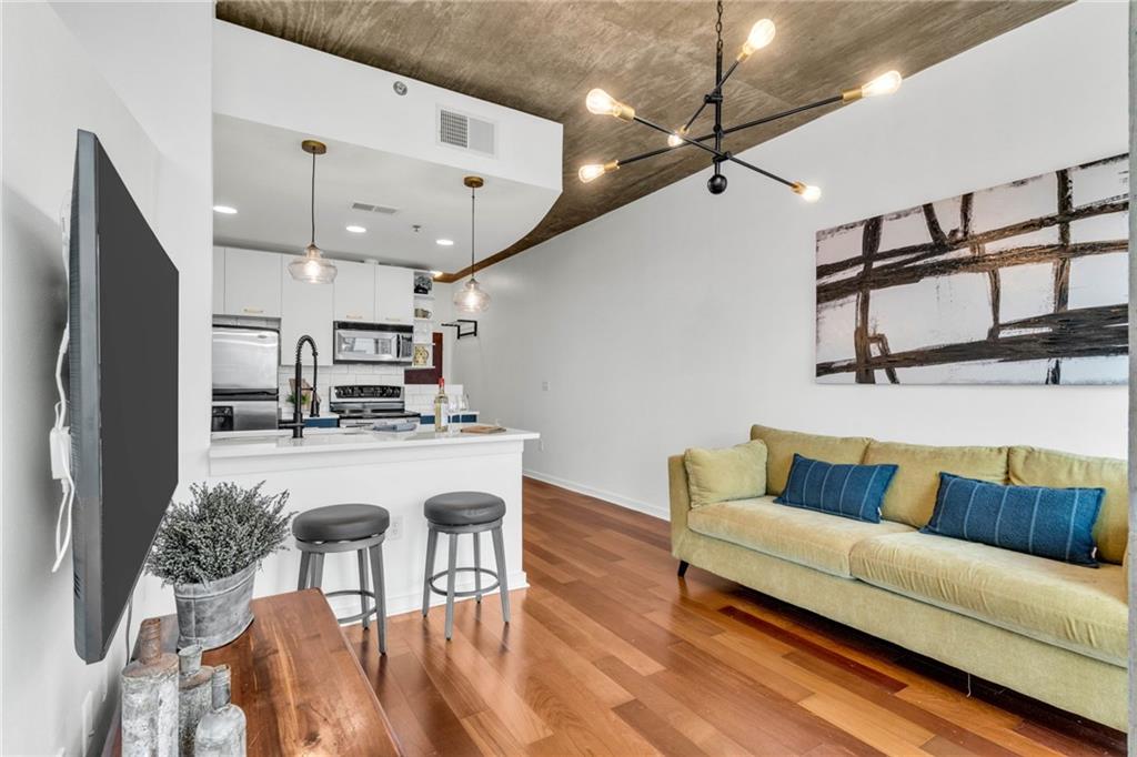 3324 Peachtree Road Northeast, Unit 1813 Atlanta, GA 30326 - Photo 7 of 34 a living room with furniture and kitchen view