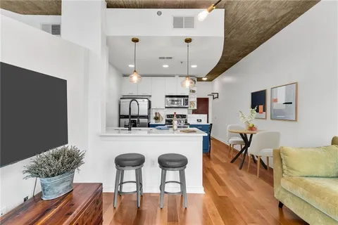 a living room with furniture and kitchen view