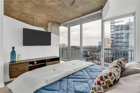 a bedroom with a bed and flat screen tv