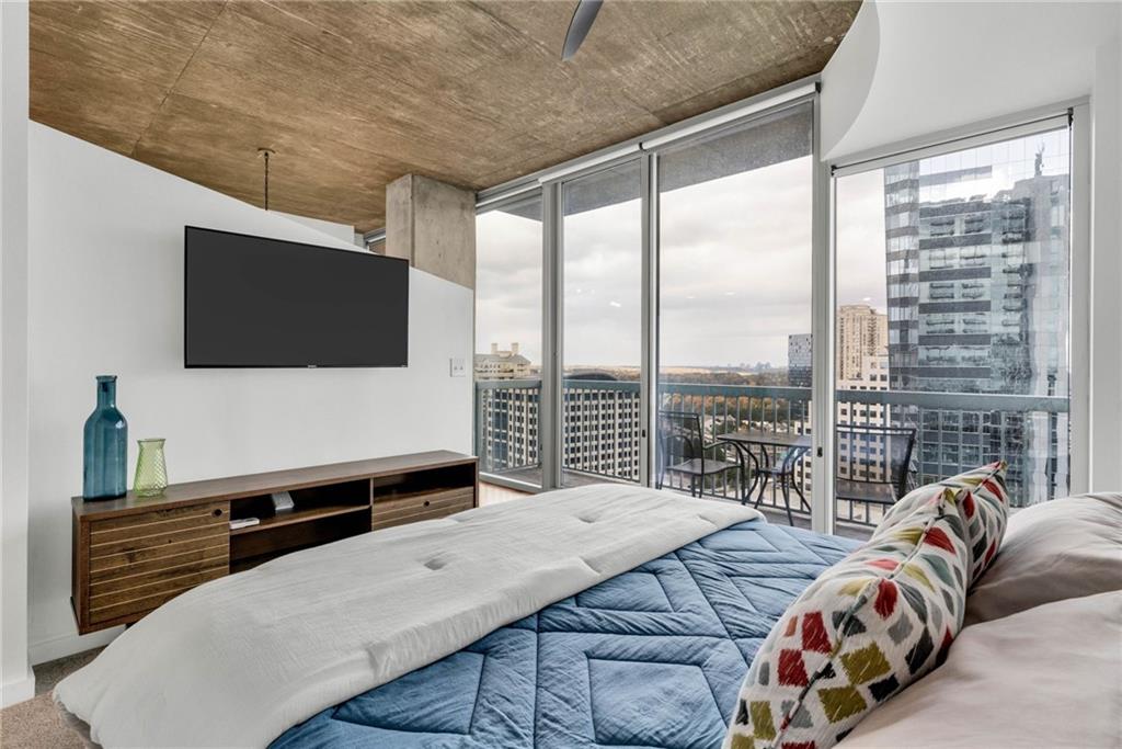 3324 Peachtree Road Northeast, Unit 1813 Atlanta, GA 30326 - Photo 10 of 34 a bedroom with a bed and flat screen tv