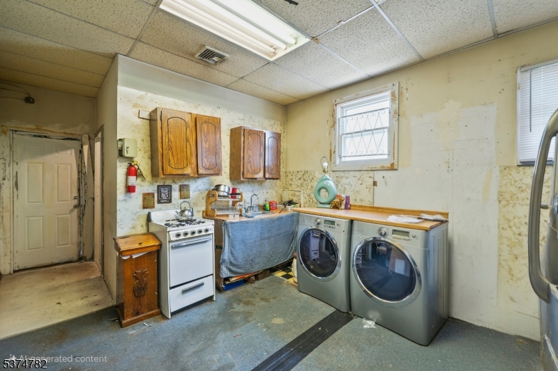 339 Hillside Avenue, Unit 2 Hillside, NJ 07205 - Photo 7 of 7 a utility room with cabinets dryer and washer