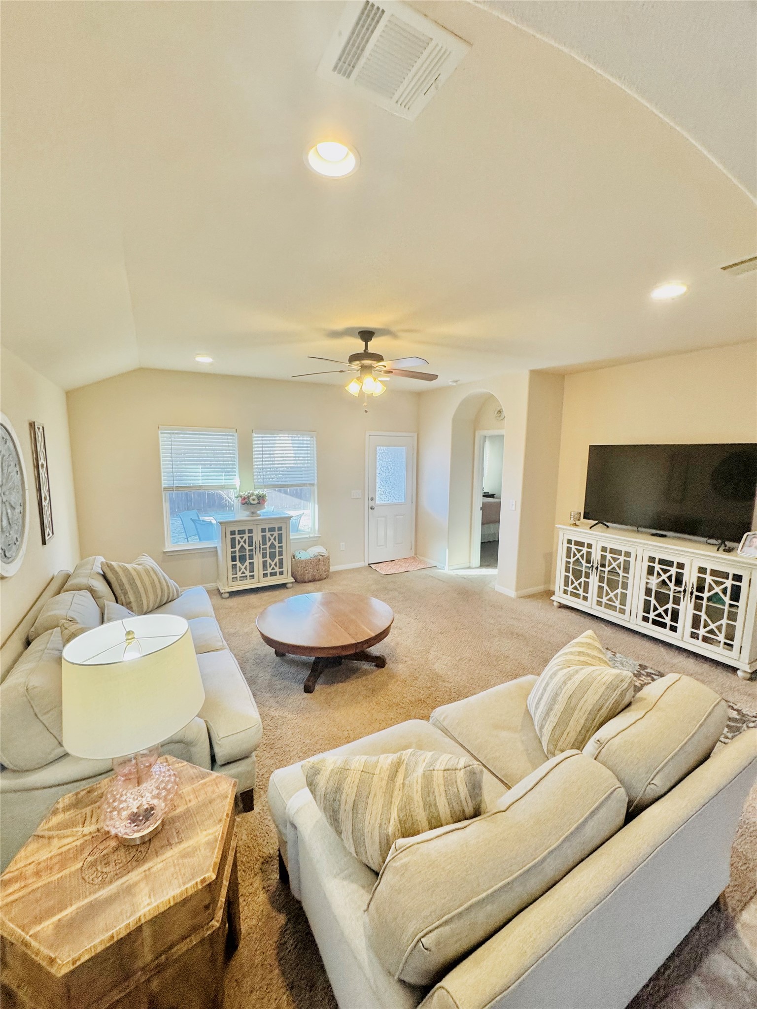413 Gettysburg Loop Elgin, TX 78621 - Photo 14 of 32 Carpeted living room featuring arched walkways, recessed lighting, vaulted ceiling, and a ceiling fan