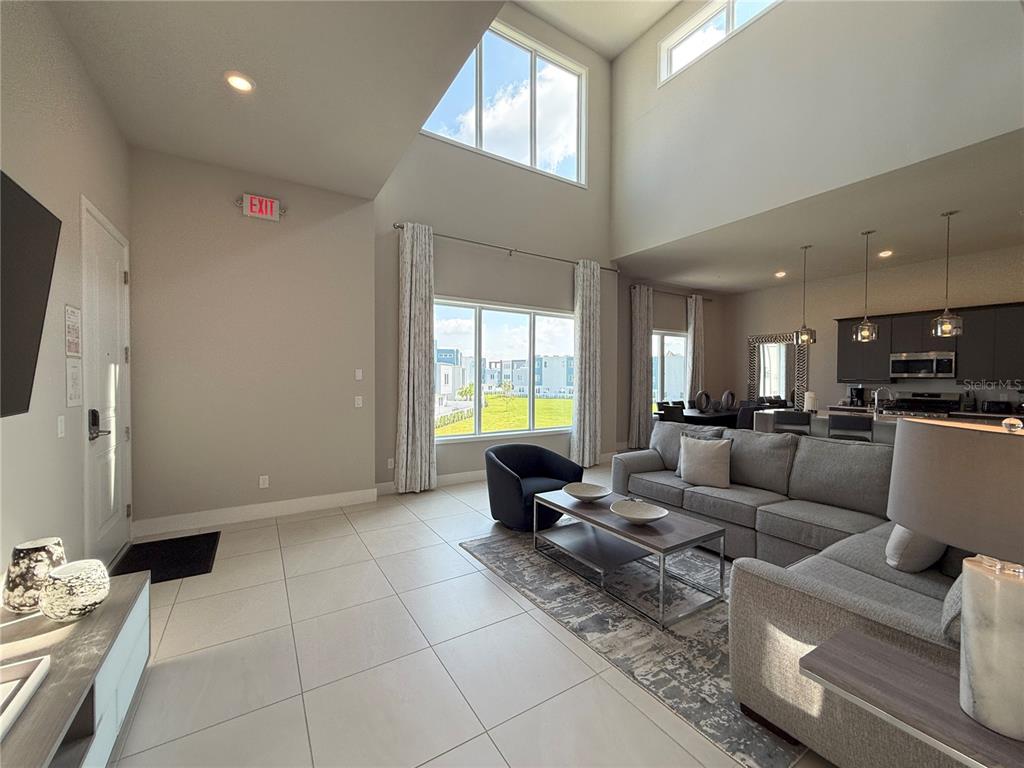 7770 Sandy Ridge Drive, Unit 231 Reunion, FL 34747 - Photo 2 of 25 a living room with furniture and a flat screen tv