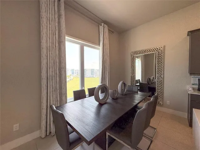a dining room with furniture and window