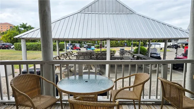 a side view of a chairs and table in the balcony