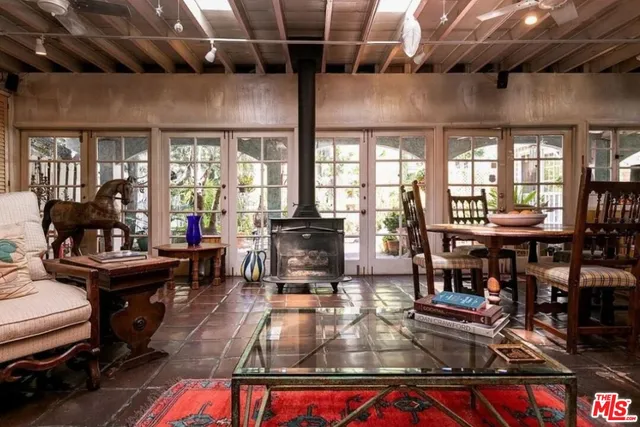 a living room with lots of furniture and a potted plant