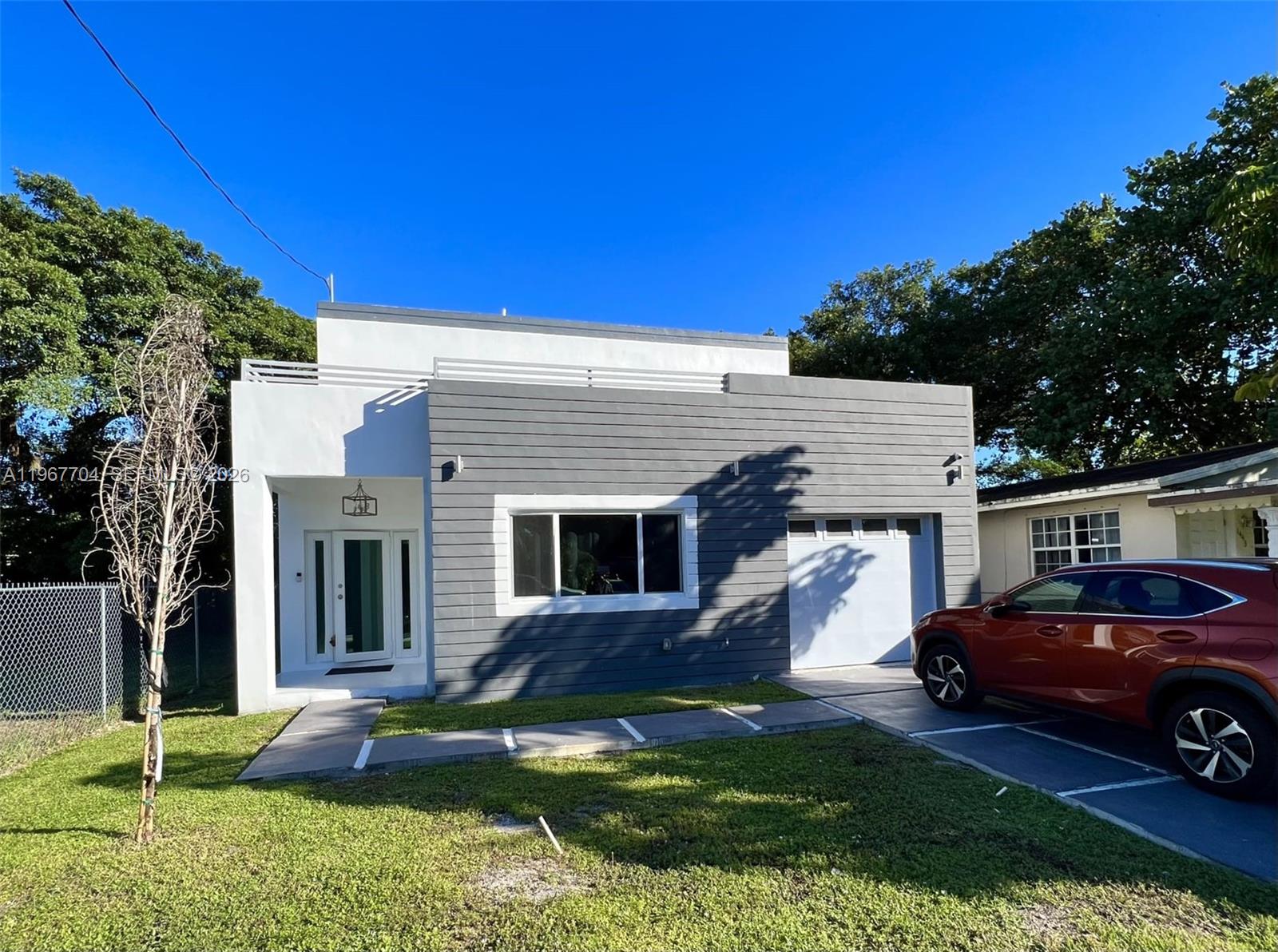 1453 Northwest 70th Street Miami, FL 33147 - Photo 18 of 19 a view of a house with a yard
