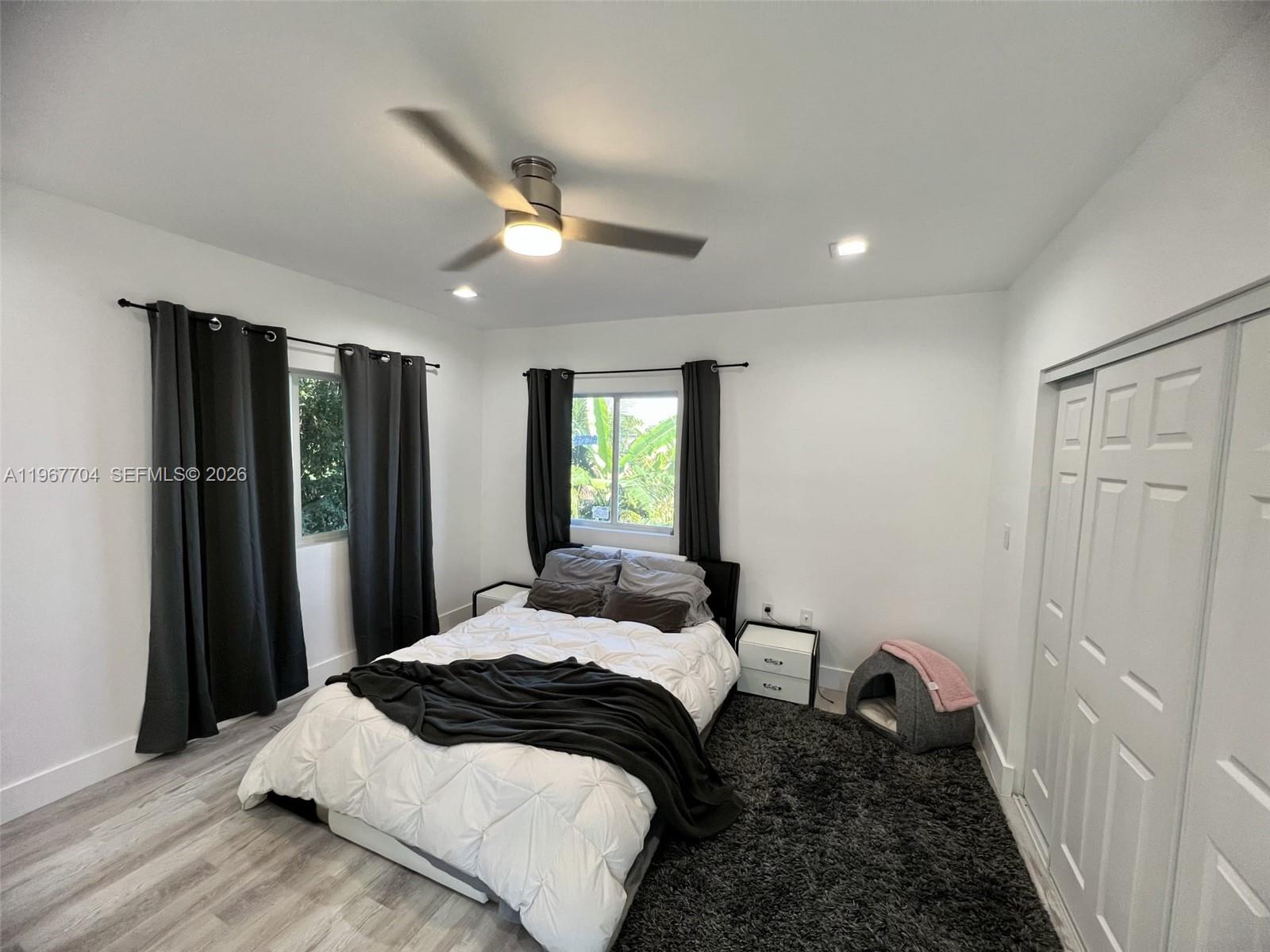 1453 Northwest 70th Street Miami, FL 33147 - Photo 3 of 19 a bedroom with a large bed and a window