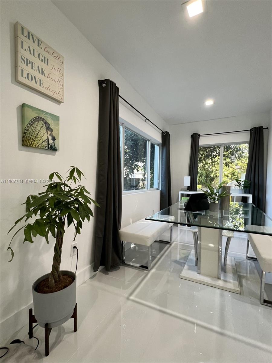 1453 Northwest 70th Street Miami, FL 33147 - Photo 6 of 19 a living room with furniture and a potted plant