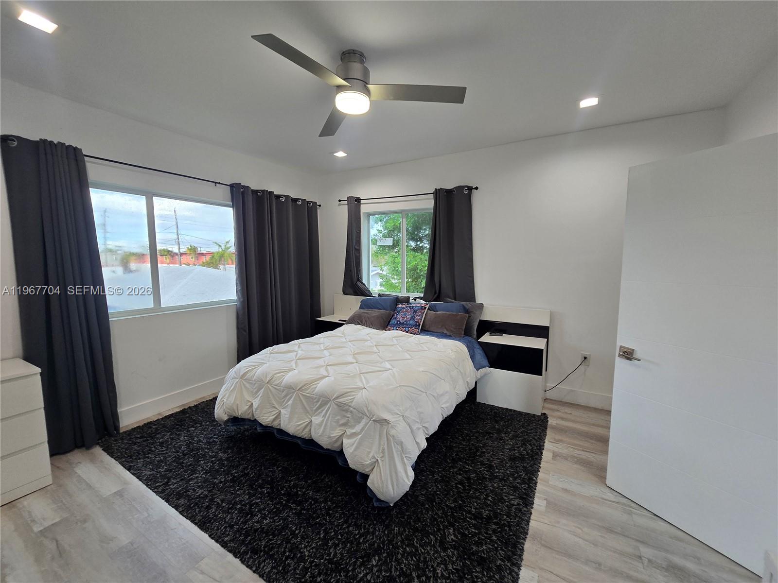 1453 Northwest 70th Street Miami, FL 33147 - Photo 9 of 19 a bed room with a bed mirror and window
