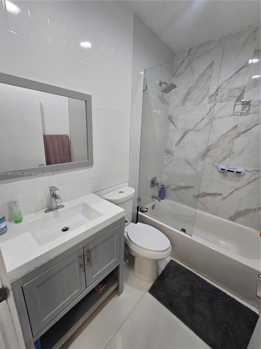 1453 Northwest 70th Street Miami, FL 33147 - Photo 10 of 19 a bathroom with a double vanity sink toilet and bathtub