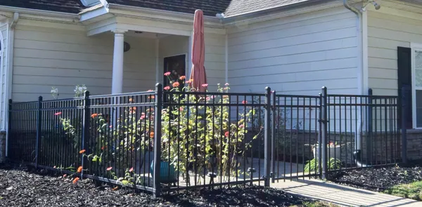 a view of a chairs and table in the yard and a fountain