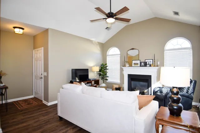 a living room with furniture and a fireplace