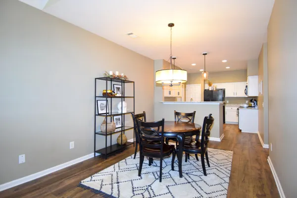 a view of a dining room with furniture and wooden floor