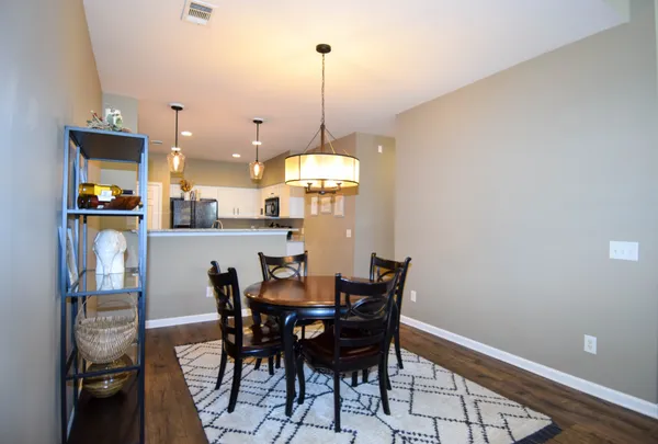a kitchen with stainless steel appliances granite countertop a sink a refrigerator and a wooden cabinets