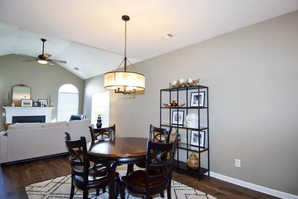 a kitchen with stainless steel appliances granite countertop a refrigerator a stove and a sink with wooden floor