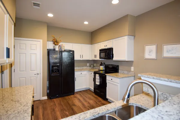 a view of a kitchen with a sink and chandelier