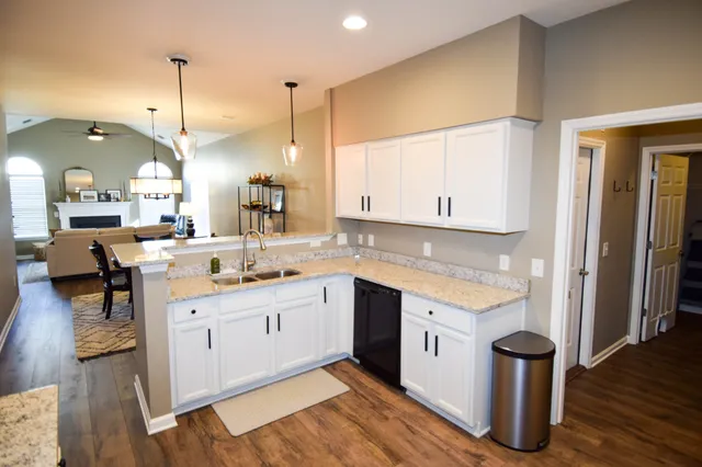 a bedroom with bed and a chandelier