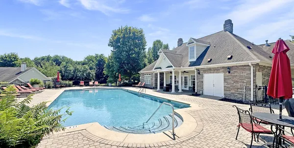 a view of a house with backyard and sitting area