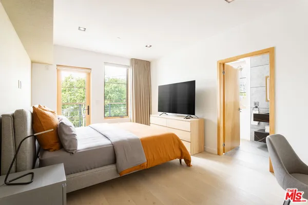 a bedroom with a bed and glass window